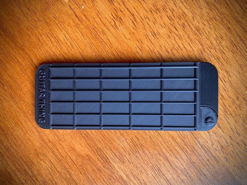 Closed Guitar Thing showing its molded string and fret positions