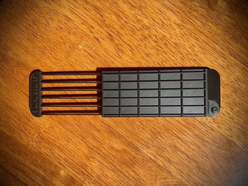 Guitar Thing slid open to expose its flexible plastic picking section